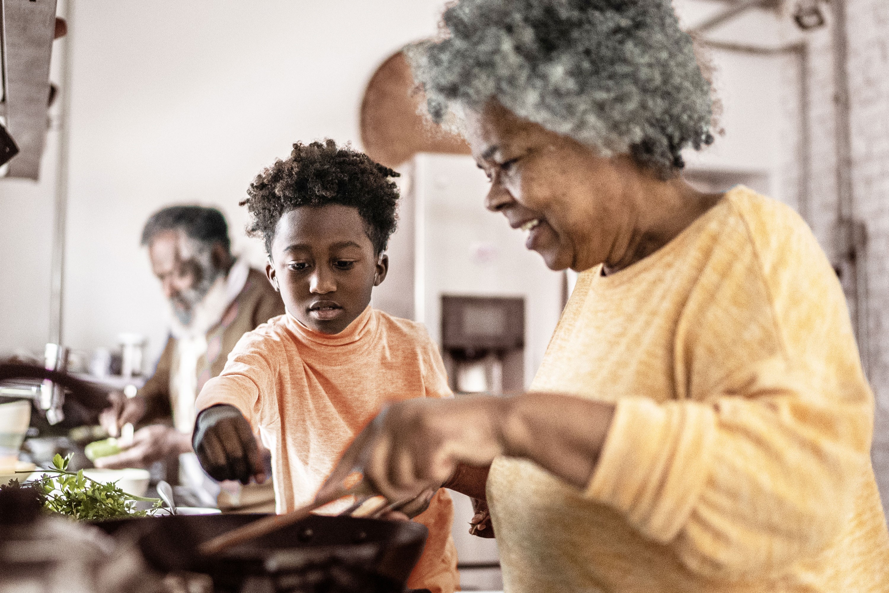 grandmother cooking with grandson
